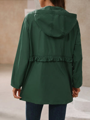 Dark green hooded windbreaker jacket with ruffled waistline detail.