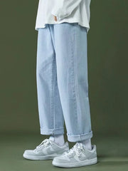 Casual oversized light wash men's jeans with cuffed hems and pockets.