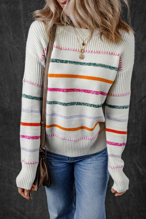 White ribbed knit pullover sweater with rainbow stripes and crew neck.