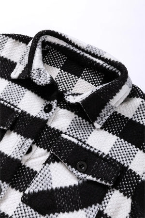 Textured checkerboard overshirt in plaid black and white with button closure and chest pockets.