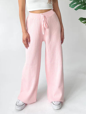 Blush pink ribbed knit palazzo trousers with drawstring waist and wide leg