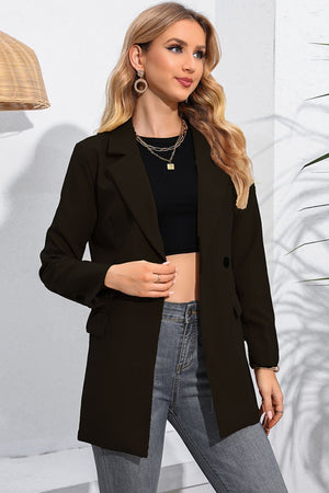 Black double-breasted blazer with flap pockets and notched lapels, worn open over a crop top.