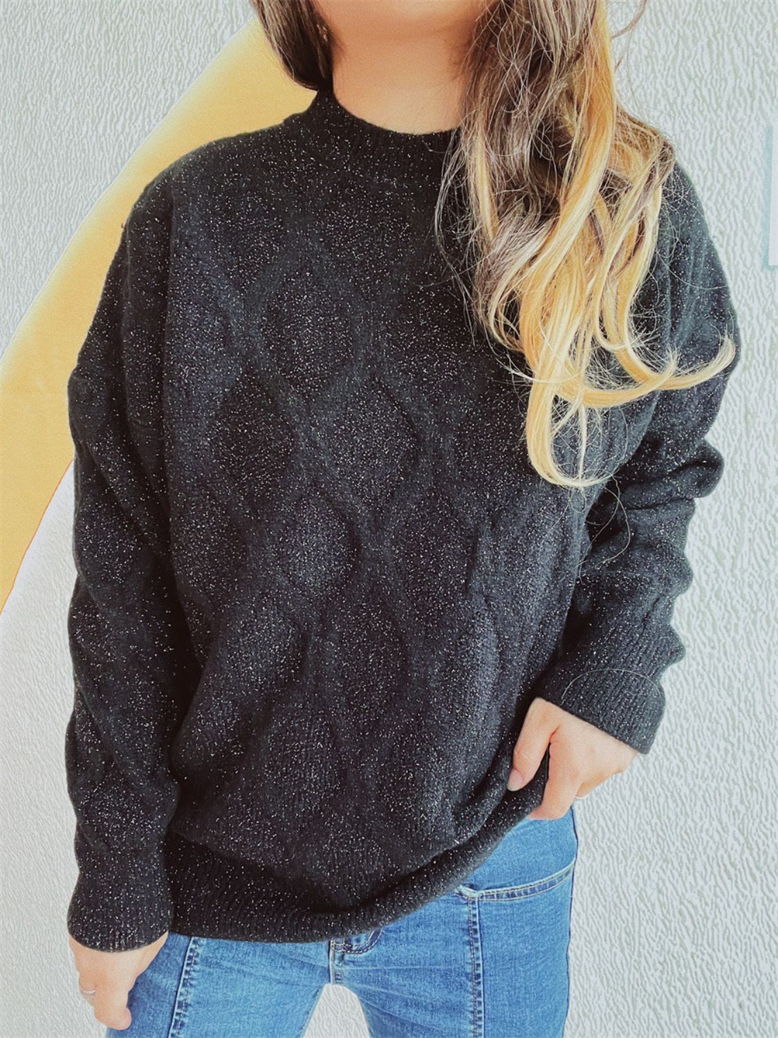 Black sparkle knit relaxed fit sweater with crewneck and long sleeves.