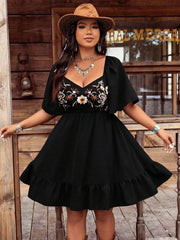 Black floral embroidered flutter sleeve dress with ruffled hem and sweetheart neckline.