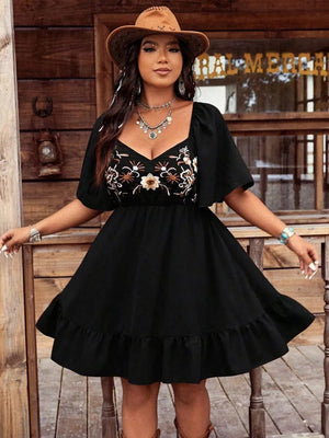Black floral embroidered flutter sleeve dress with ruffled hem and sweetheart neckline.