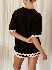 Black lounge set with scalloped trim on short sleeves and shorts