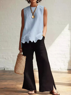 Sky blue sleeveless tank top with scalloped hem detail.
