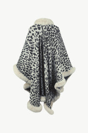 Leopard print cape with faux fur trim and collar in beige and black acrylic.