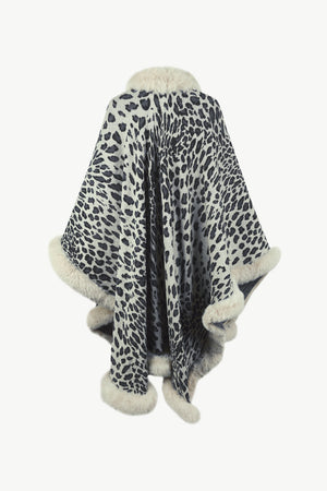 Leopard print cape with faux fur trim and collar in beige and black acrylic.
