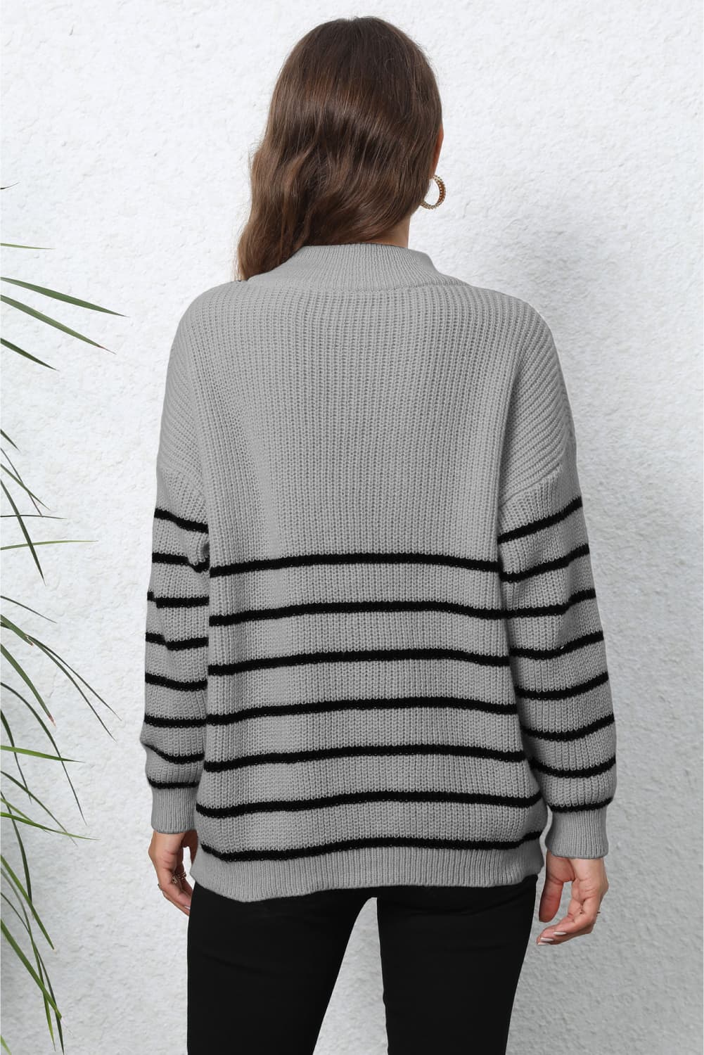 Gray ribbed knit quarter-zip sweater with black horizontal stripes.