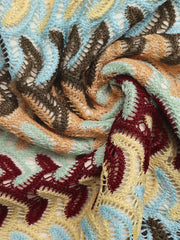 Vibrant crochet mini skirt with a colorful chevron pattern and open knit detail.