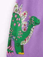 Purple toddler dress with green dinosaur applique and floral accents.