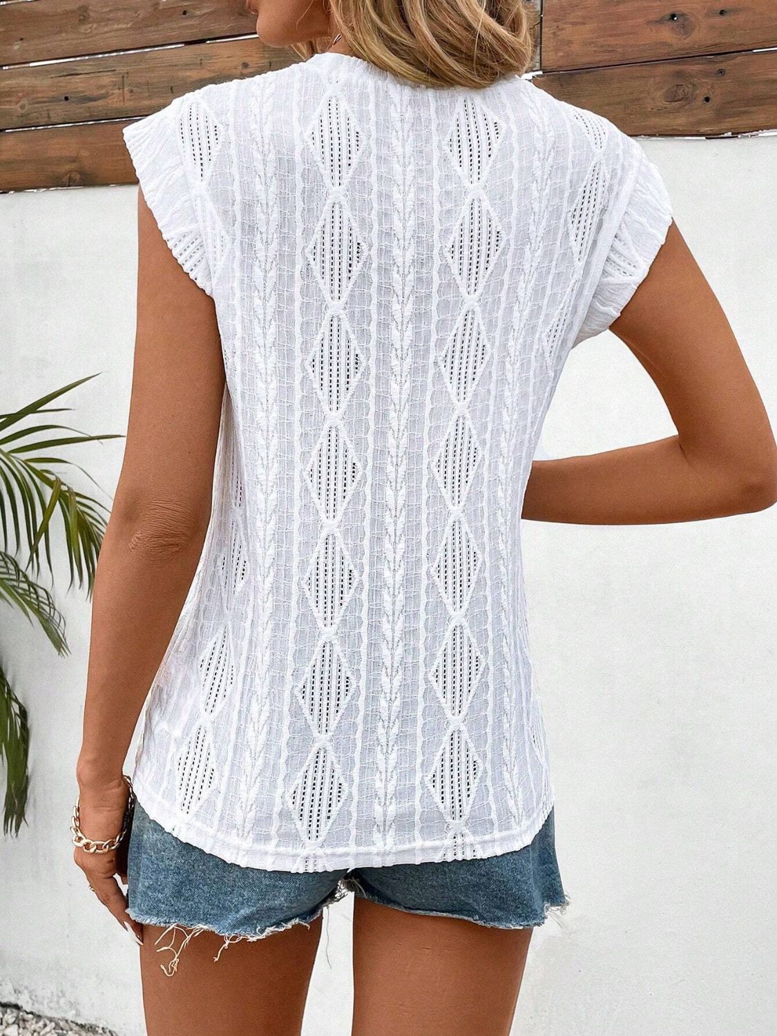 White diamond knit flutter sleeve blouse with open weave detail.