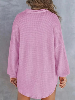 Waffle-knit henley tee in light purple with long sleeves and a collared neckline.