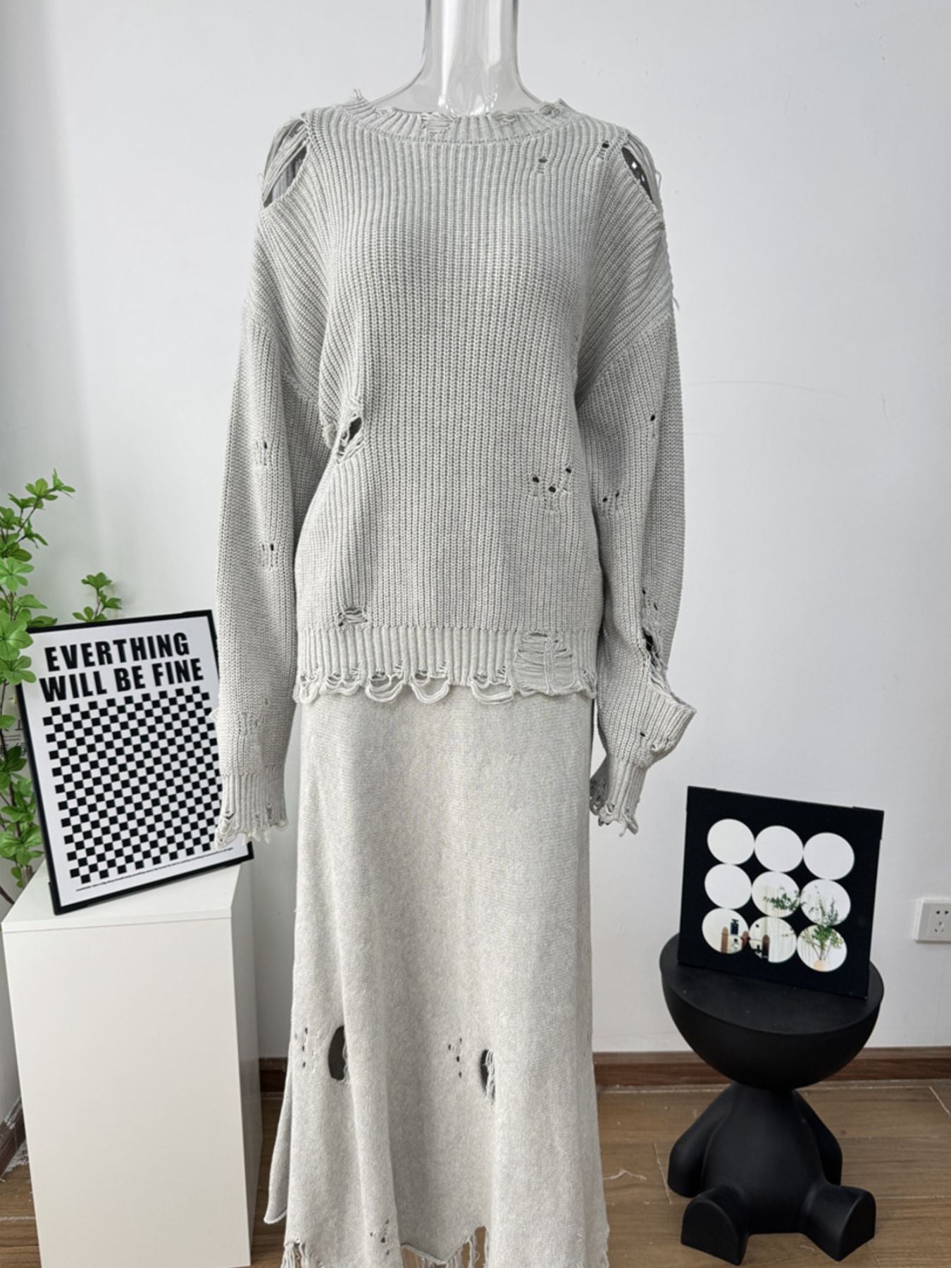 Light gray distressed cotton knit sweater and midi skirt outfit set with deconstructed details.