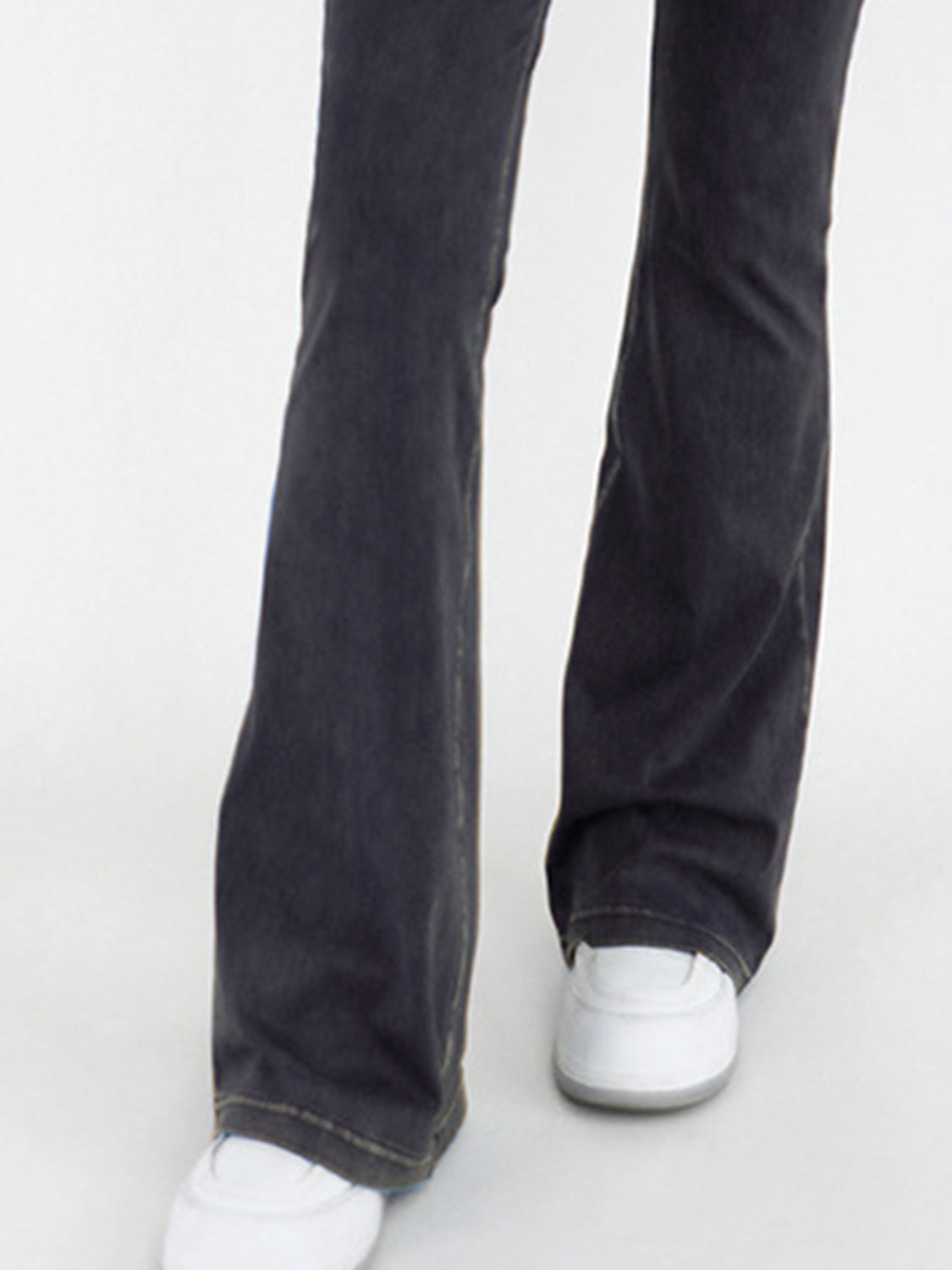 Charcoal crossover waist flare jeans with a bootcut leg and contrast stitching.