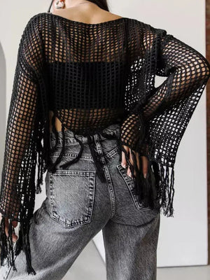 Black openwork crochet cover-up with fringe detail and long sleeves.