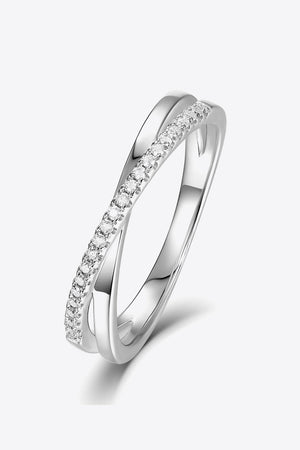 Silver eternity crossover ring with pavé moissanite band on sterling silver.