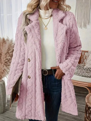 Pink faux shearling double-breasted coat with cable knit texture and button closure.