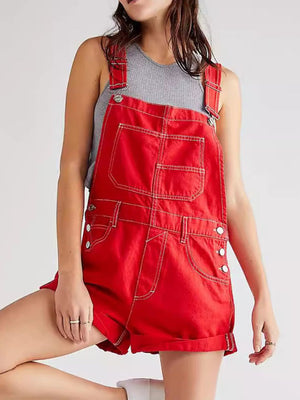 Crimson denim short overalls with contrast stitching and cuffed hems.