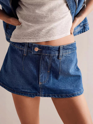Denim mini skort in dark blue with button closure and contrast stitching.