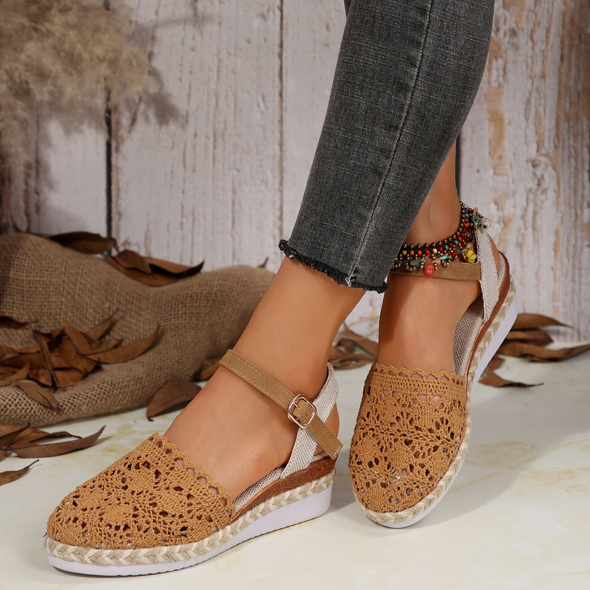 Brown crochet espadrille sandals with ankle strap and beaded detail.