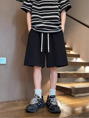 Men's black lightweight drawstring shorts with white drawstrings