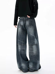 Belted wide-leg jeans in dark wash denim with unique paneled design and baggy fit.