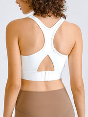 White sculpted racerback crop top with cutout detail and hook-and-eye closure.