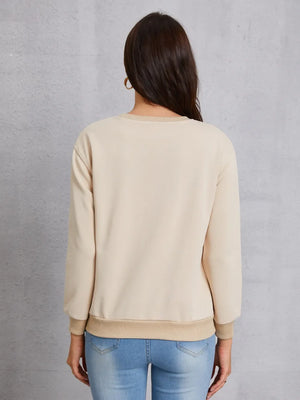 Khaki sweatshirt with crew neck and ribbed cuffs and hem, worn with jeans.