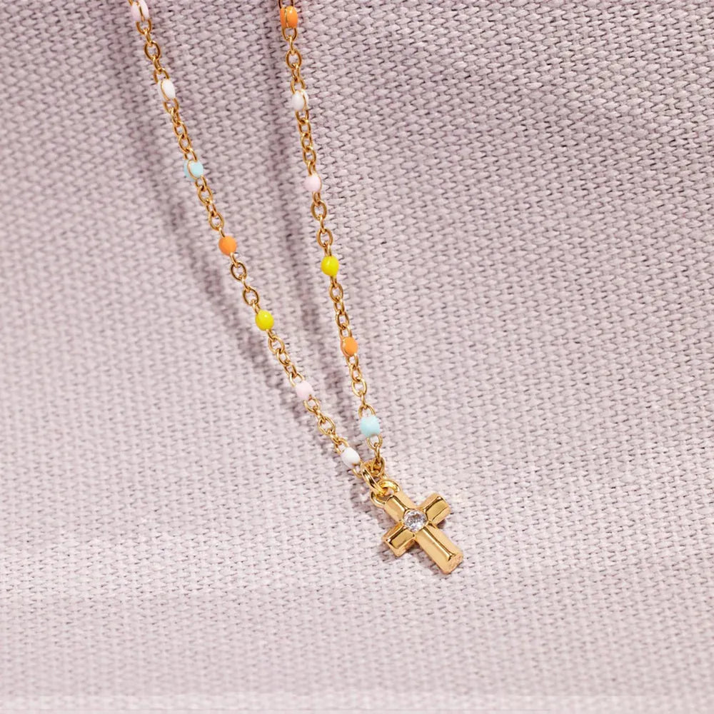 Gold bead necklace with rainbow beads and a crystal cross pendant.
