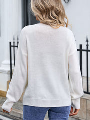 White knit sweater with embroidered bloom appliqué detail on sleeve