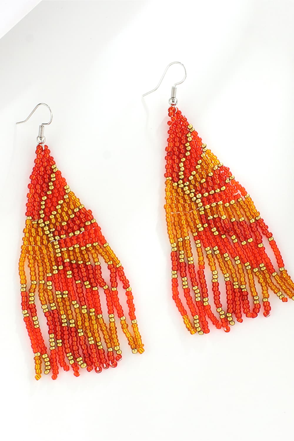 Chic beaded drop earrings in orange and gold with fringe detail