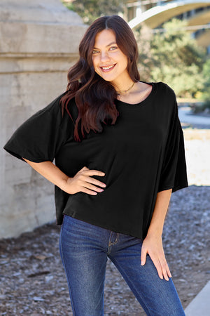 Black boxy dolman crop t-shirt with relaxed fit and short sleeves.