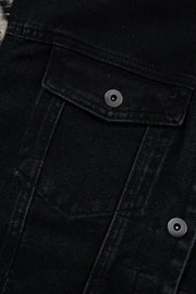 Black denim trucker jacket with snap button chest pockets and metal hardware.