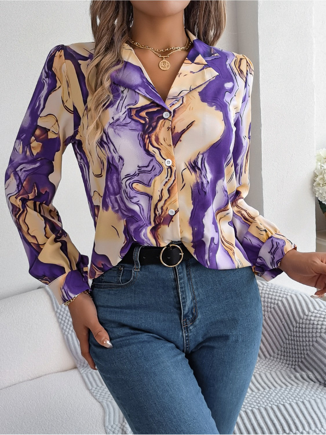 Women's abstract swirl print silk blouse with button front and long sleeves.