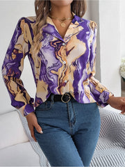 Women's abstract swirl print silk blouse with button front and long sleeves.