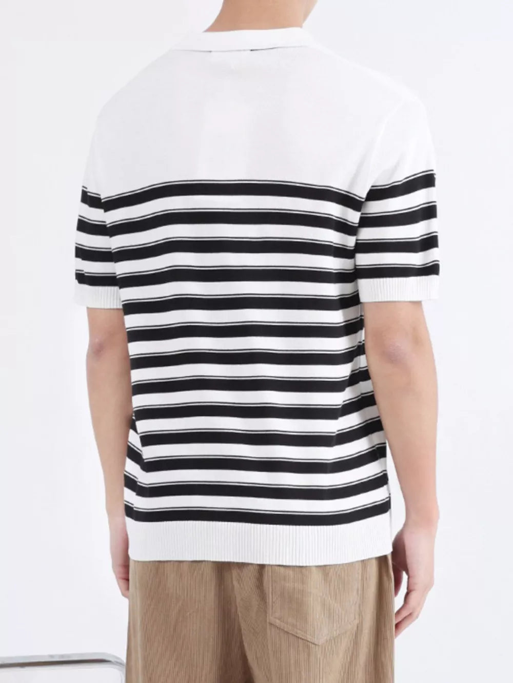 Men's striped knit polo shirt with short sleeves and a white collar, featuring horizontal black and white stripes.