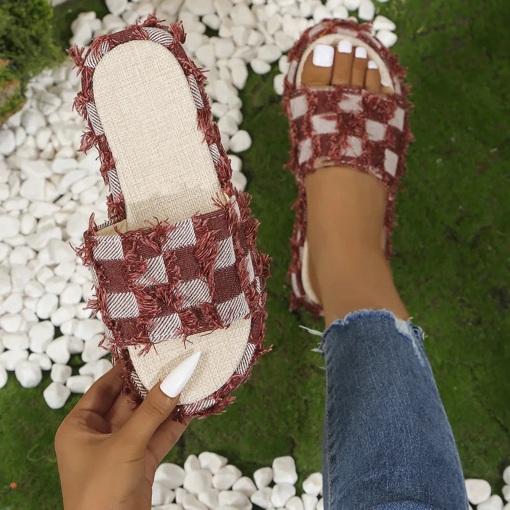 Textured checkered platform slides in burgundy with fringe detail.