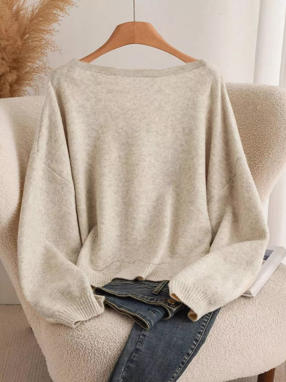 Khaki V-neck cardigan with balloon sleeves and bow-knot detail, styled with jeans.