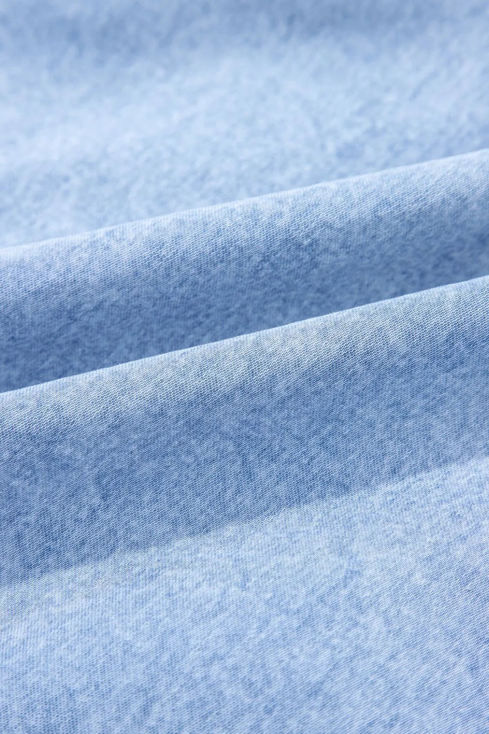 Light blue denim sundress with ruffled hem detail
