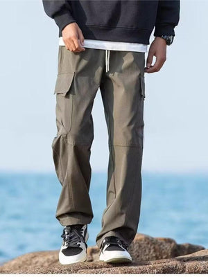 Relaxed fit army green cargo pants with flap pockets and drawstring waist.