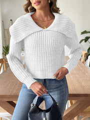 White ribbed knit sweater with shawl collar and long sleeves, styled with jeans and a black handbag.