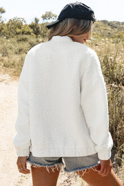 White bomber jacket with allover floral texture, mock neck, and elastic cuffs.