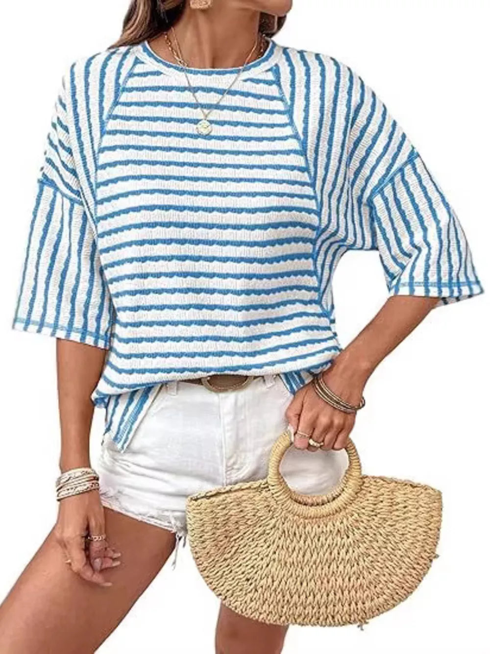 Light blue and white wavy stripe knit t-shirt with relaxed fit and short sleeves.