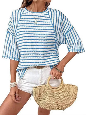 Light blue and white wavy stripe knit t-shirt with relaxed fit and short sleeves.