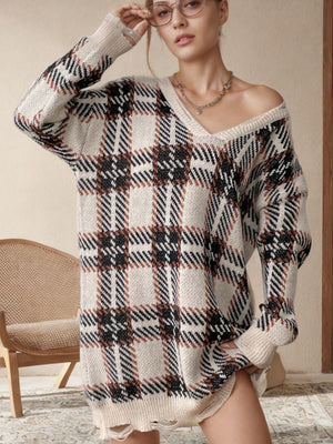Plaid knit tunic with distressed hem, V-neck, and long sleeves in tan and black plaid.