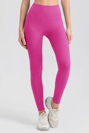 Pink high-waist performance leggings with sculpting seams and a full-length cut.