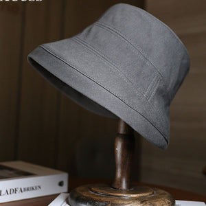 Dark Gray cotton bucket hat with stitched details and a wide brim.