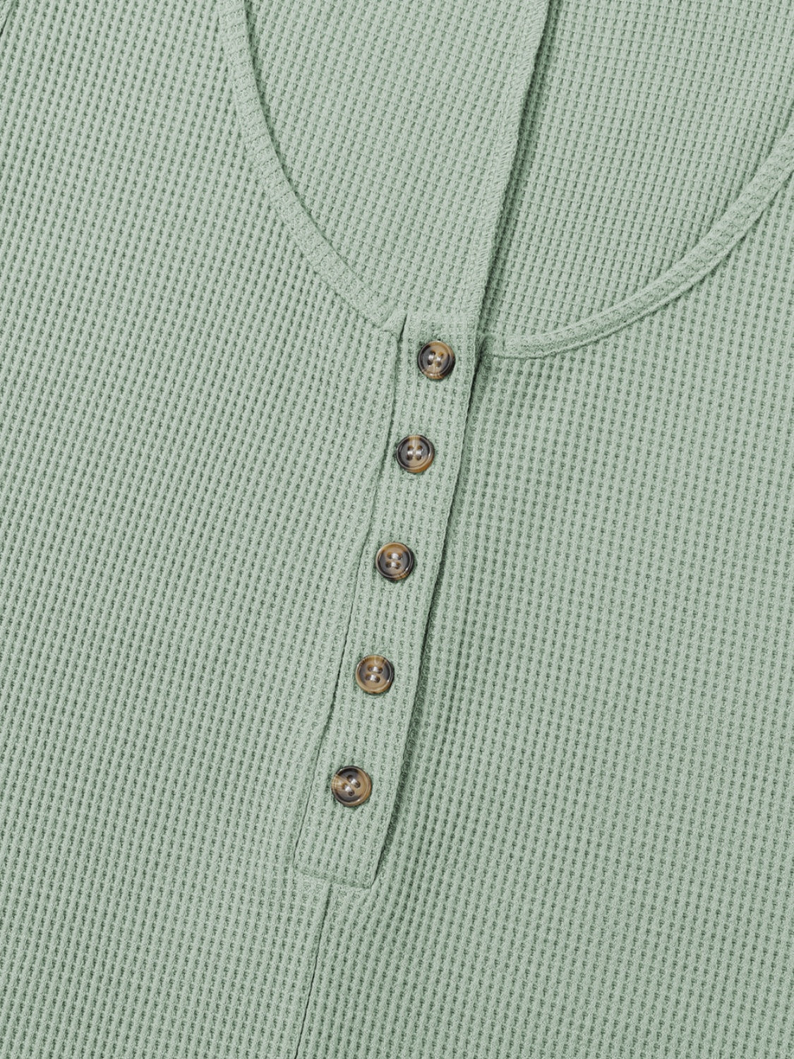 Sage green waffle knit button-down romper with round neckline and brown buttons.